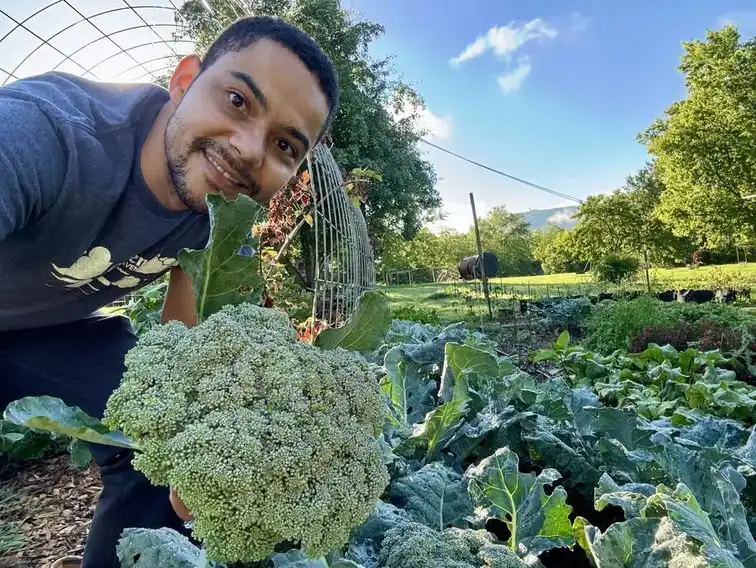 Man Smiling with Fresh Garden Broccoli 2024 salud, vida en el campo Beckfords Ministry